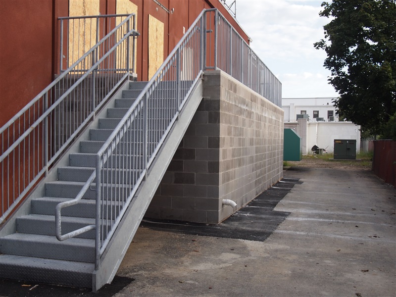 Stairs and upper level with gray pipe railings